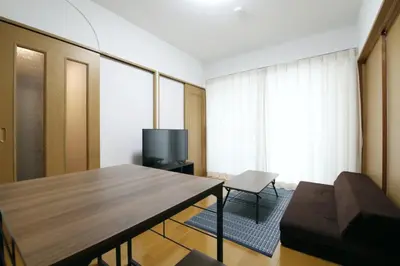 a living room with a table and a television at Voere\u5927\u4e95\u753a 201 in Tokyo
