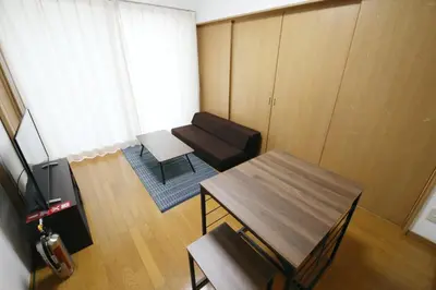 a living room with a table and a chair at Voere\u5927\u4e95\u753a 201 in Tokyo