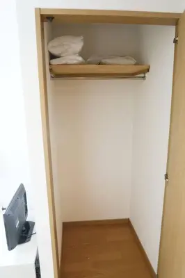 a small room with a closet with a bed and a shelf at Voere\u5927\u4e95\u753a 302 in Tokyo