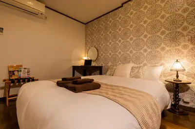 a bedroom with a white bed with towels on it at IROHA STAY HANEDA - Family-Friendly Home Stay near Haneda with Great Access to Tokyo & Yokohama in Tokyo