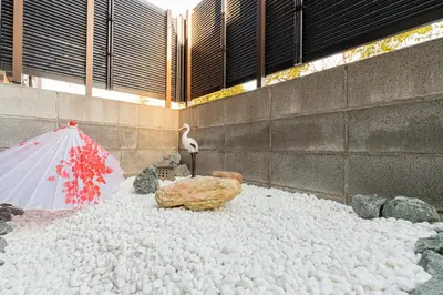 a bird and an umbrella on a pile of rocks at IROHA STAY HANEDA - Family-Friendly Home Stay near Haneda with Great Access to Tokyo & Yokohama in Tokyo