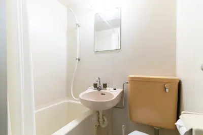 a bathroom with a sink and a toilet and a shower at \u30a8\u30b9\u30ab\u30eb\u690e\u540d\u753a in Tokyo