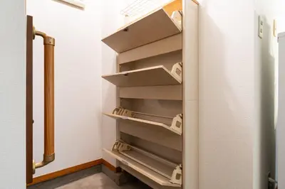 a refrigerator with empty shelves in a room at \u30e1\u30be\u30f3\u7d4c\u5802 in Tokyo