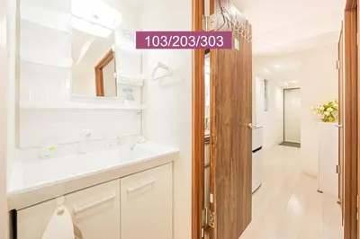 a bathroom with a sink and a mirror at Shinjuku Downtown 1min walk to metro Cozy APT in Tokyo