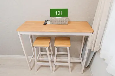 a small table with two stools in a room at Shinjuku Downtown 1min walk to metro Cozy APT in Tokyo