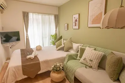a living room with a bed and a couch at 3mins from Nakano subway,Direct to Shinjuku,Up to 4 People in Tokyo