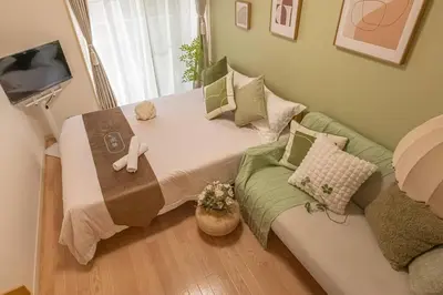 a bedroom with a large bed and a couch at 3mins from Nakano subway,Direct to Shinjuku,Up to 4 People in Tokyo