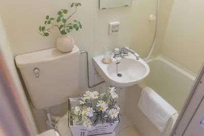a bathroom with a toilet and a sink with flowers on it at 3mins from Nakano subway,Direct to Shinjuku,Up to 4 People in Tokyo