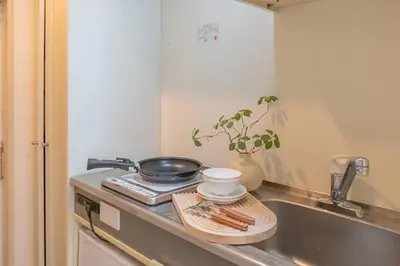 a kitchen counter with a frying pan and a sink at 3mins from Nakano subway,Direct to Shinjuku,Up to 4 People in Tokyo