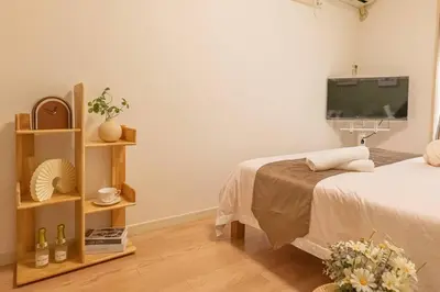 a bedroom with a bed and a flat screen tv at 3mins from Nakano subway,Direct to Shinjuku,Up to 4 People in Tokyo