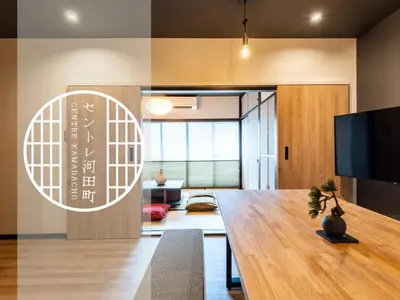 a living room with a table and a tv at \u30bb\u30f3\u30c8\u30ec\u6cb3\u7530\u753a in Tokyo