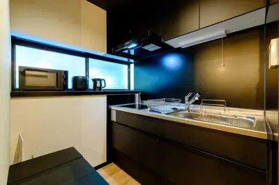 a kitchen with a sink and a microwave at \u30bb\u30f3\u30c8\u30ec\u6cb3\u7530\u753a in Tokyo