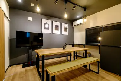 a dining room with a table and a refrigerator at \u30bb\u30f3\u30c8\u30ec\u6cb3\u7530\u753a in Tokyo