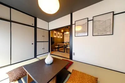 a living room with a table and a couch at \u30bb\u30f3\u30c8\u30ec\u6cb3\u7530\u753a in Tokyo