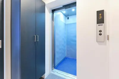 a shower with a blue door in a bathroom at Metro Gate by Tranova in Tokyo