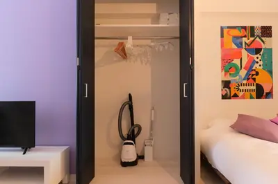 a room with a bedroom with a bed and a closet at Metro Gate by Tranova in Tokyo