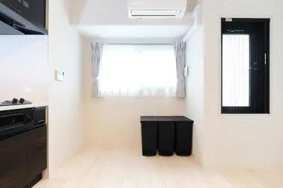 a kitchen with a black table and a window at Metro Gate by Tranova in Tokyo