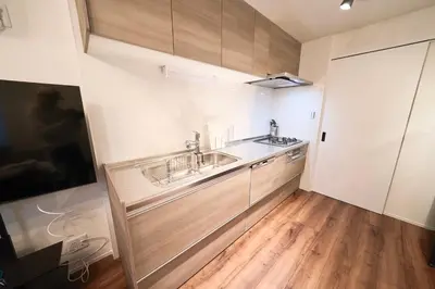a kitchen with two sinks and a wooden floor at TOMARIE Residential Suite Kita-Senju in Tokyo
