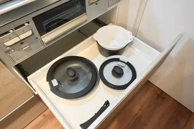 a small kitchen with a stove and a sink at TOMARIE Residential Suite Kita-Senju in Tokyo