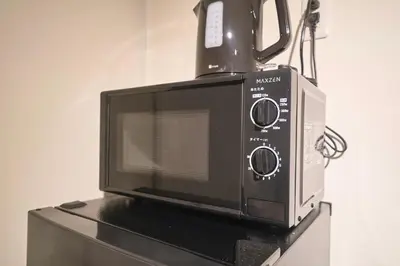 a microwave oven sitting on top of a counter at TOMARIE Residential Suite Kita-Senju in Tokyo