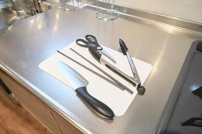 a knife and scissors sitting on top of a counter at TOMARIE Residential Suite Kita-Senju in Tokyo