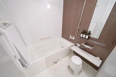 a bathroom with a tub and a toilet and a sink at TOMARIE Residential Suite Kita-Senju in Tokyo