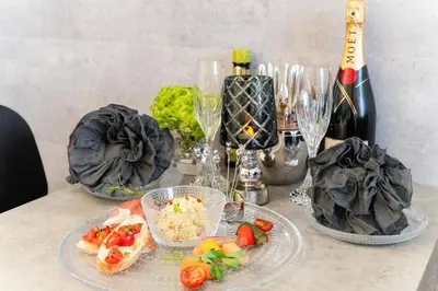 a table with plates of food and bottles of wine at Sangenjaya Modern Stay in Tokyo