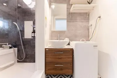a bathroom with a sink and a mirror and a shower at Sangenjaya Modern Stay in Tokyo