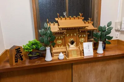 a wooden shrine sitting on top of a counter with plants at 634 Musashi Feel Traditional-Japanese culture,Ikebukuro-area in Tokyo