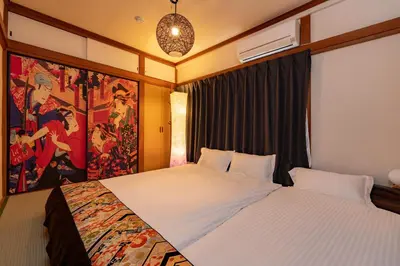 a bedroom with a large bed with a painting on the wall at 634 Musashi Feel Traditional-Japanese culture,Ikebukuro-area in Tokyo