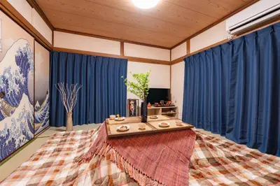a living room with blue curtains and a table at 634 Musashi Feel Traditional-Japanese culture,Ikebukuro-area in Tokyo