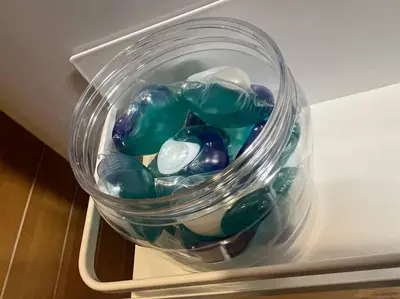a glass jar filled with green and white glass marbles at \u65c5\u306e\u5bbfhitotoki in Tokyo