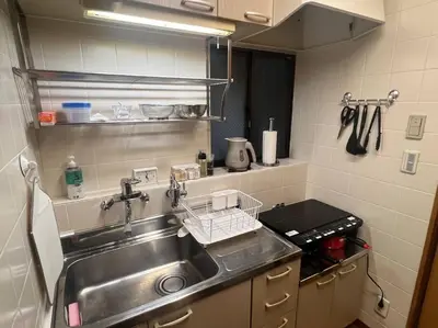 a kitchen sink with a dish drying rack next to it at \u65c5\u306e\u5bbfhitotoki in Tokyo