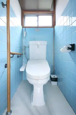 a bathroom with a white toilet in a blue bathroom at Machiya \u4eac Asakusa in Tokyo