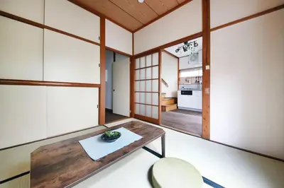 a small room with a table and a kitchen at Machiya \u4eac Asakusa in Tokyo