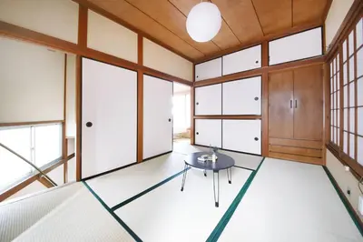 a room with a table and some windows at Machiya \u4eac Asakusa in Tokyo