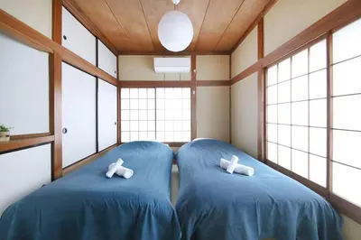 two blue chairs in a room with windows at Machiya \u4eac Asakusa in Tokyo