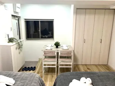 a small room with a table and a bedroom at Ikebukuro Area R2 NishiikeApartment 5F No Elevator in Tokyo