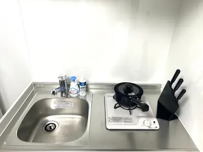 a kitchen counter with a sink with a pot on it at Ikebukuro Area R2 NishiikeApartment 5F No Elevator in Tokyo