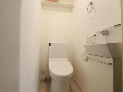 a white bathroom with a toilet and a sink at New Open\u6771\u65b0\u5bbf \u6238\u5efa in Tokyo