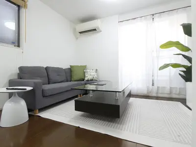 a living room with a couch and a coffee table at New Open\u6771\u65b0\u5bbf \u6238\u5efa in Tokyo