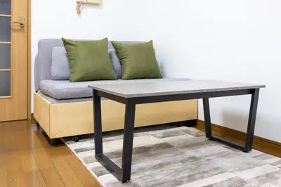 a couch sitting next to a table with a couch at \u5357\u9752\u5c71227\u30d3\u30eb in Tokyo