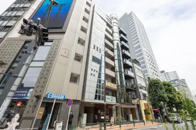 a tall building on a city street with a traffic light at \u5357\u9752\u5c71227\u30d3\u30eb in Tokyo