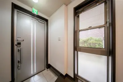 a corridor with a door and a window in a building at \u6c60\u888b\u5f92\u6b6911\u5206\u8981\u753a\u99c53\u5206 3\u968e\u5efa\u3066\u4e00\u8ed2\u5bb6 \u6700\u59278\u4eba \u8cb8\u5207 \u30ad\u30c3\u30c1\u30f3\u8a2d\u5099\u5b8c\u5099 \u5bdd\u5ba44\u3064 \u30c8\u30a4\u30ec2\u3064 in Tokyo