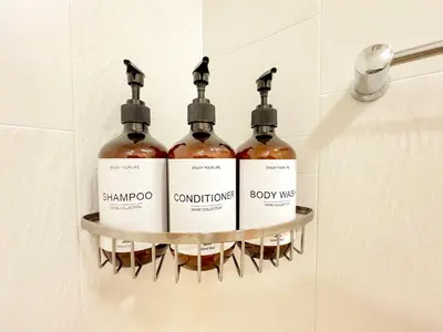 four bottles of wine on a shelf in a bathroom at Shinjuku Downtown BZT Free WiFi in Tokyo