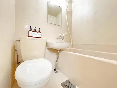 a white bathroom with a toilet and a sink at Shinjuku West Cozy WZE Free WiFi in Tokyo