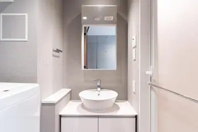a white bathroom with a sink and a mirror at Lega land\u4e2d\u91ce\u5bcc\u58eb\u898b\u753a in Tokyo