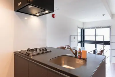 a kitchen with a sink and a stove at Lega land\u4e2d\u91ce\u5bcc\u58eb\u898b\u753a in Tokyo