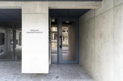 an entrance to a building with a blue door at Lega land\u4e2d\u91ce\u5bcc\u58eb\u898b\u753a in Tokyo