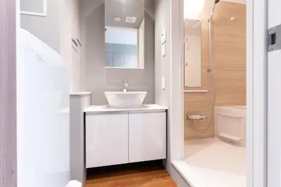 a bathroom with a sink and a shower at Lega land\u4e2d\u91ce\u5bcc\u58eb\u898b\u753a in Tokyo